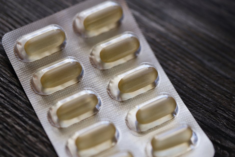 Detailed view of a blister pack with transparent capsules on a textured wooden background.