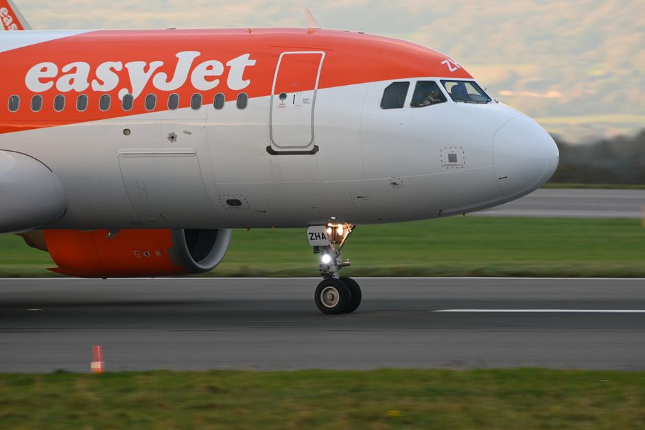 EasyJet airplane on the runway ready for departure at Bristol Airport. Side view close-up.