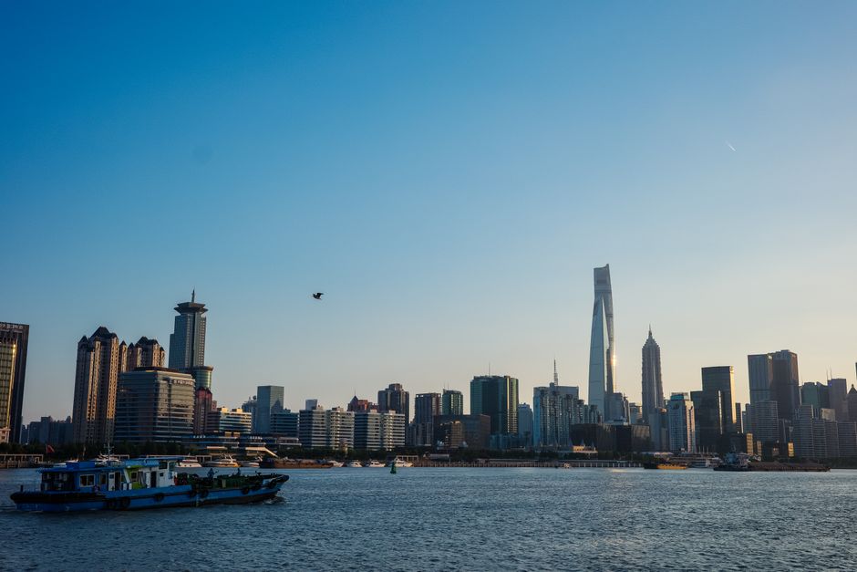 Scenic view of Shanghai skyline at dusk with modern high-rise buildings and waterfront.